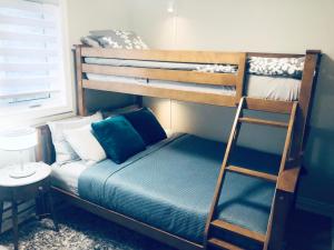 a bedroom with a bunk bed with a ladder at Stylish 2bed, 2bth Apt Malls & 25 Mins To Toronto in Mississauga +42 photos