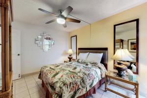 a bedroom with a bed and a ceiling fan at Island Sands Resort 103 in Maalaea +16 photos