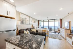 a kitchen and a living room with a couch at Maui Kai 707 in Kaanapali Airport