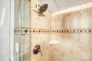 a bathroom with a shower with a glass door at Maui Kai 707 in Kaanapali Airport +11 photos