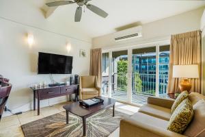 a living room with a couch and a tv at Kauai Kailani 319 in Waipouli