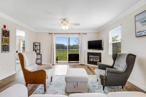 a living room with two chairs and a fireplace at Bethany Bay - 8004 Pettinaro Dr in Cedar Shores