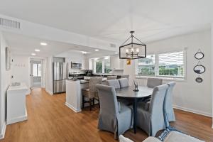 a dining room and kitchen with a table and chairs at SG10C: 10C Seagrove Villa in Isle of Palms