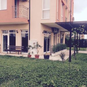 a building with a bench in front of it at Guest House SNG in Nesebar