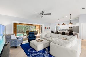 a living room with a white couch and a kitchen at Barfield Bay Tuckaway in Rookery Island