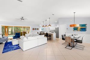 a living room with a white couch and a kitchen at Barfield Bay Tuckaway in Rookery Island