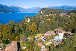 an aerial view of a house next to a lake at Lenni Apart Swimming Pool and lake - Happy Rentals in Leggiuno +19 photos