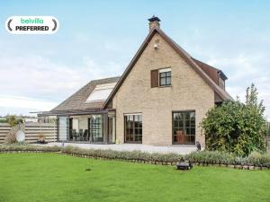 a large brick house with a grass yard at Holiday Home in Groede near Sandy Beach in Groede +6 photos
