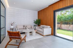 a living room with a couch and a table at Villa Anzar Refined Oasis wChef and Emerald Hammam in El Rhechat