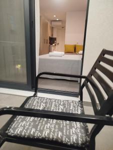 a black chair in a room with a bed at Elegant Dream Suites in Ayia anna +1 photo