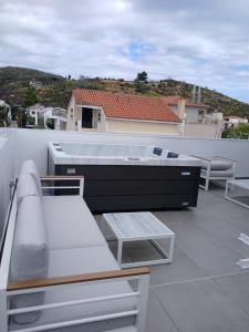 a balcony with a table and chairs on a roof at Elegant Dream Suites in Ayia anna