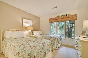 a bedroom with two beds and a window at IC106: 106 Inlet Cove in Kiawah Island +39 photos