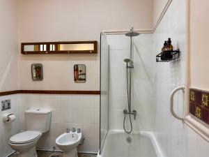 a bathroom with a toilet and a sink and a shower at Lina's Tango Guesthouse in Buenos Aires +51 photos