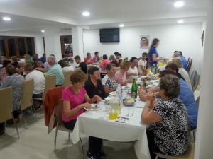 a group of people sitting at tables in a room at Pansion Turudić in Međugorje