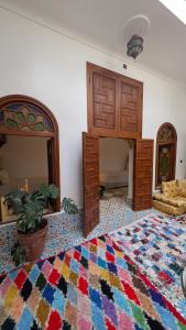 a living room with a colorful rug on the floor at Dar Ribati in Sale
