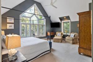 a bedroom with a bed and a large window at SS52: 52 Surfsong in Kiawah Island