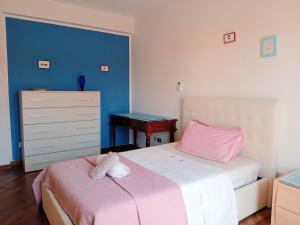 a bedroom with two beds and a dresser at casa mare bellissima in Alghero