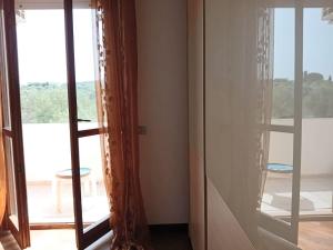 a room with glass doors with a view of a balcony at casa mare bellissima in Alghero