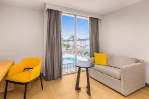 a living room with a couch and a table at B&B HOTEL Orlando International Drive near Universal - Newly Renovated! in Orlando