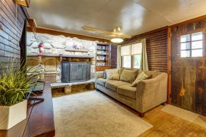 a living room with a couch and a fireplace at Rustic Bedford Cabin Near Hunting and Fishing in Bedford