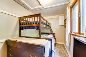 a small bedroom with a bunk bed and a dresser at Rustic Bedford Cabin Near Hunting and Fishing in Bedford