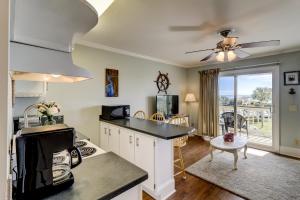 a kitchen with a counter top and a living room at SC217A: 217A Sea Cabin in Isle of Palms