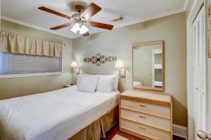 a bedroom with a bed and a ceiling fan at SC217A: 217A Sea Cabin in Isle of Palms +20 photos