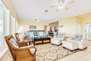 a living room with a couch and chairs at Ultimate Beachfront Beach Access Fenced Yard in Hercules Offshore Heliport
