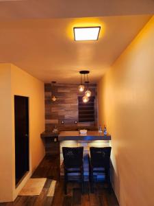 a kitchen with two chairs and a bar in a room at Villas Mar Arena in Isla Aguada