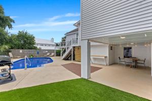 a patio with a table and a swimming pool at AV4-22: 4 22nd Avenue in Isle of Palms