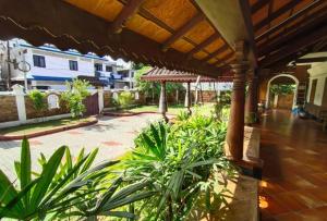 eine Veranda eines Hauses mit Pflanzen in der Unterkunft Azza by Travelista in Kochi