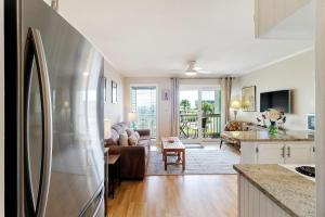 a kitchen and living room with a stainless steel refrigerator at SC206A: 206A Sea Cabin in Isle of Palms