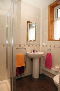 a bathroom with a sink and a shower at Global Holiday Rooms in Luss