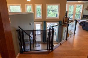 a staircase in a living room with a stair railing at Luxury spacious home, free parking, private patios in Eureka Springs