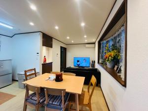 a room with a table and chairs and a kitchen at TSURUNOYA The only private lodging in Tokyo Japanese TATAMI style 8 minutes walk from station FREE Parking 4rooms 12guests NEW OPEN ASAKUSA AKIHABARA SKYTREE nearby in Tokyo +38 photos