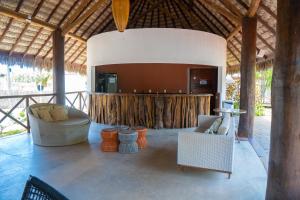 a lobby of a resort with chairs and a bar at Villas BobZ Ap 110 in Barrinha