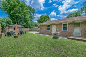 a brick house with a yard with chairs and a gazebo at Modern 2 Bedroom Home with Fire Pit, Bikes in Portsmouth