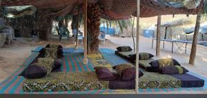 a group of pillows laying on a bed in a tent at Aubergre Toule in Terjit +8 photos