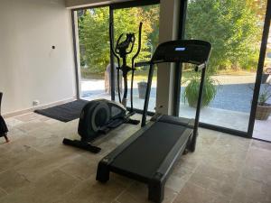 a gym with a treadmill and a exercise bike at Cosy studio 2 personnes in Varennes Vauzelles