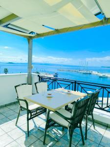 a table and chairs on a balcony with a view of the ocean at Anna Maria - Vanessa Apartments in Neo Klima