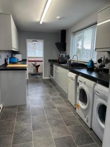 a kitchen with a washer and dryer at 4 bed Laurel Drive Newport TF10 in Newport
