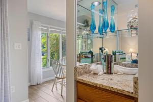 a room with a counter with books and blue vases at TC5556: 5556 Turtle Cove in Kiawah Island +30 photos