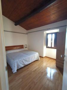 a bedroom with a bed and a window at Le coste sul lago in Montefiascone