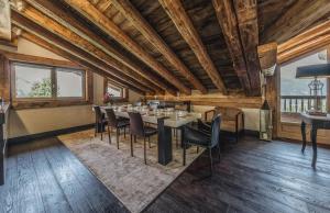 a dining room with a table and chairs at Chalet Rte Brigues Courchevel in Courchevel