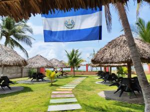 a flag of the dominican republic hanging on a palm tree at Coconut village in El Zapote +4 photos