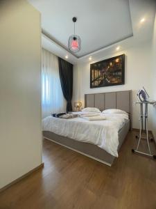 a bedroom with a large bed and a tripod at kestel city in Alanya +30 photos
