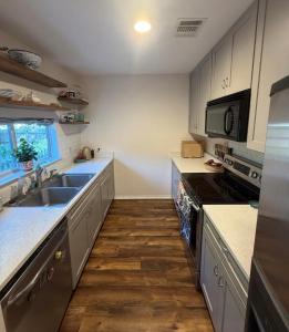 a kitchen with a sink and a stove at Peaceful cottage in San Antonio