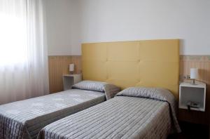 Posteľ alebo postele v izbe v ubytovaní Albergo Ristorante Belvedere