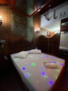 a bed with purple lights on it in a room at Motel Pousada do Cowboy in Sao Paulo