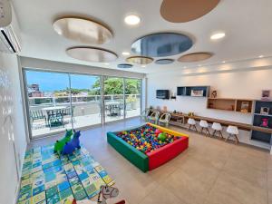 a living room with a large ball pit in the middle at Mila Rooftop - Praia de Tamandaré in Tamandaré +122 photos